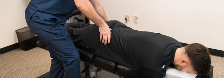 Chiropractor Charlotte NC Logan Hiers Adjusting A Patient
